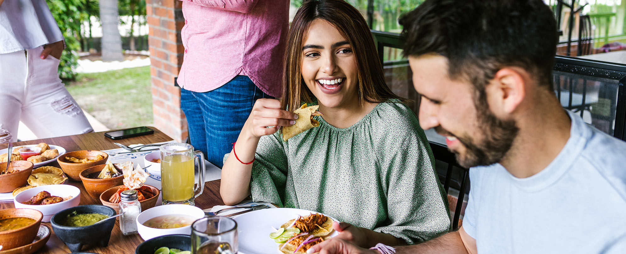 A man and a woman eating a meal.