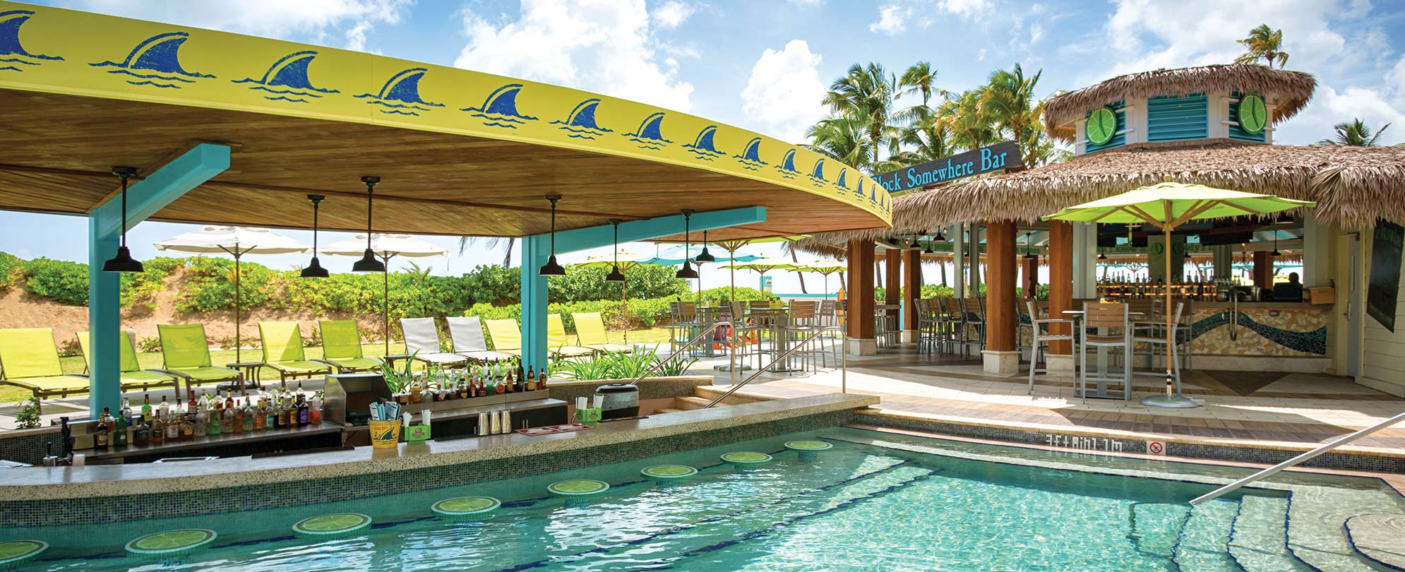 A swim-up bar with the Landshark logo at the pool of Margaritaville Vacation Club by Wyndham - Rio Mar.