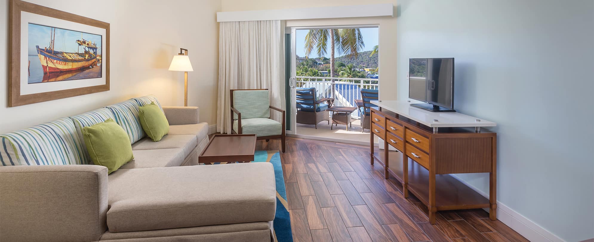 Couch and tv in the living room of a suite at Margaritaville Vacation Club by Wyndham - St. Thomas.