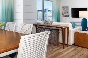 Chic living and dining room decorated with wood furniture at Margaritaville Vacation Club by Wyndham - Desert Blue in Las Vegas, NV.